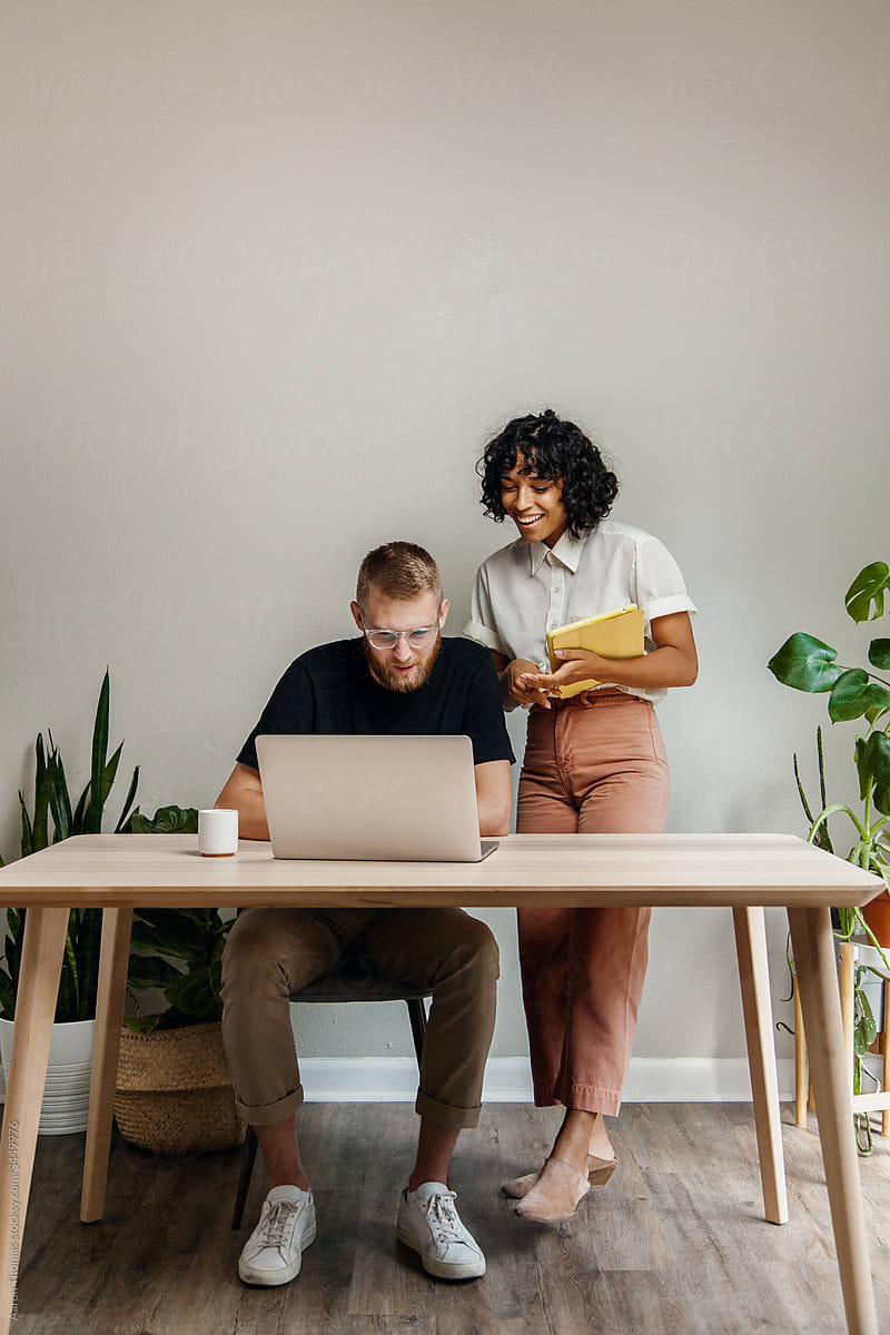 Two people looking at a laptop.